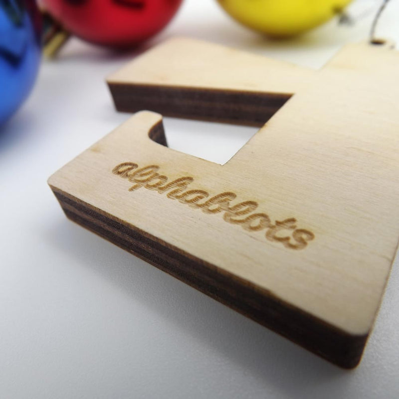 closeup back view typographic laser cut plywood letter l christmas tree decoration