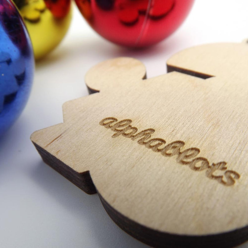 closeup back view typographic laser cut yellow plywood ampersand christmas tree decoration